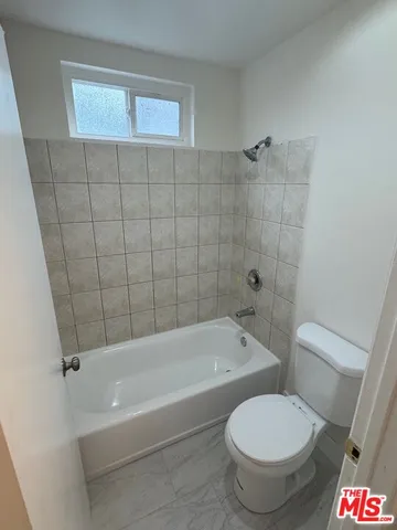 a bathroom with a toilet and a bathtub