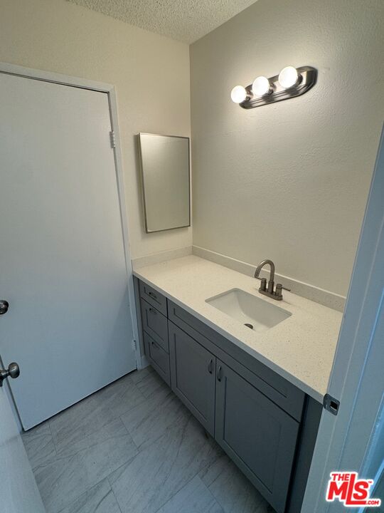 428 South Grand View Street Los Angeles, CA 90057 - Photo 17 of 29 a bathroom with a sink and a mirror