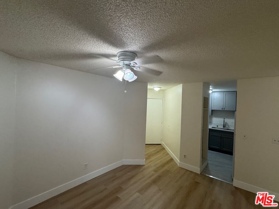 428 South Grand View Street Los Angeles, CA 90057 - Photo 4 of 29 an empty room with wooden floor and bathroom view