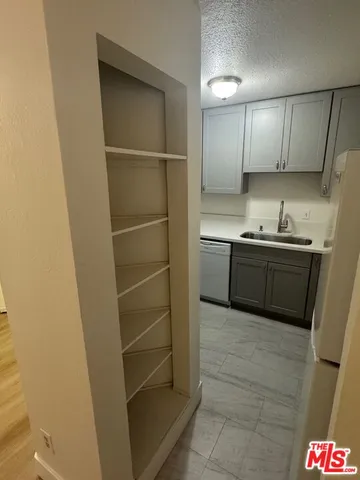a kitchen with stainless steel appliances a sink and cabinets