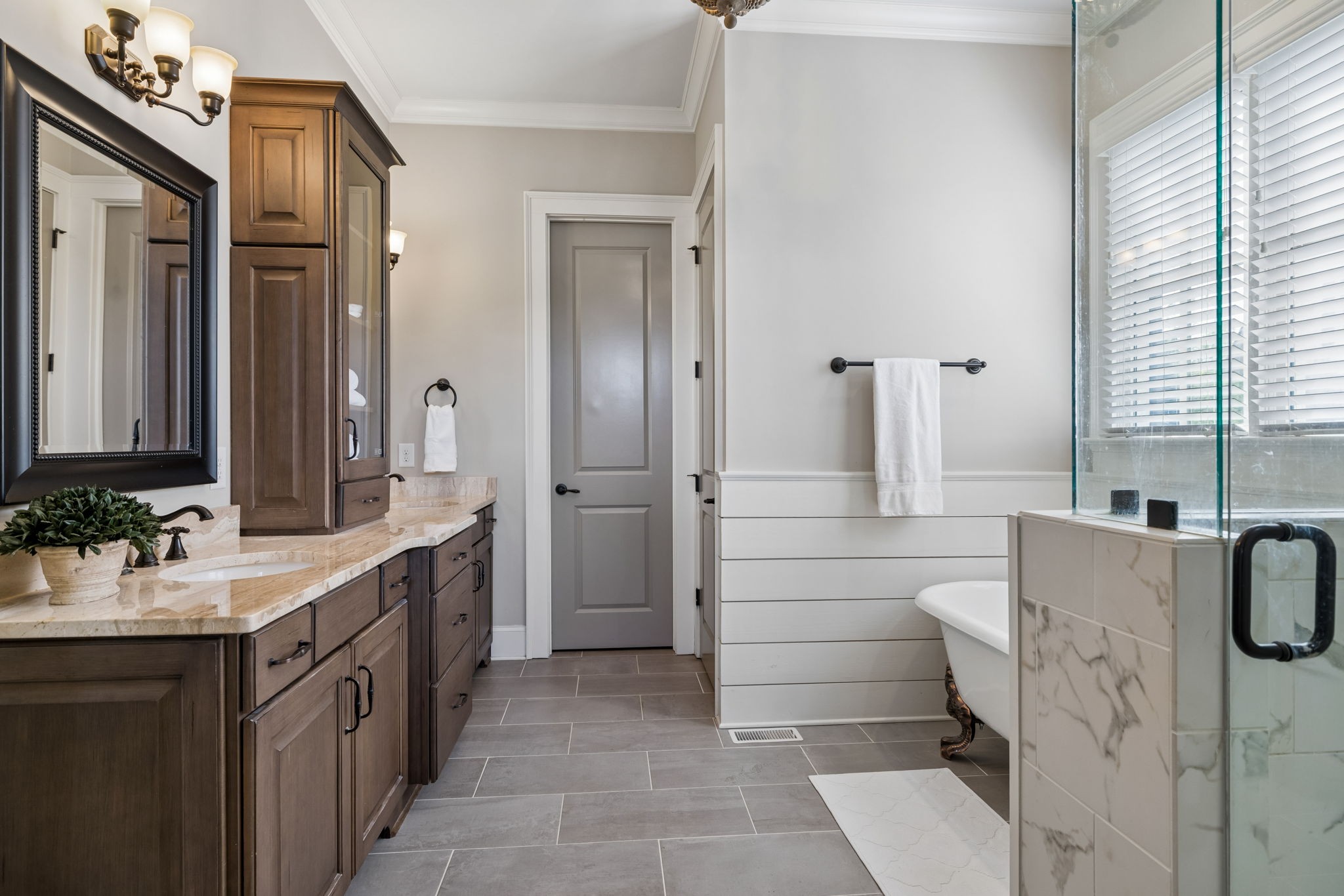 6033 Native Pony Trail College Grove, TN 37046 - Photo 48 of 87 a bathroom with a double vanity sink a mirror and a bathtub