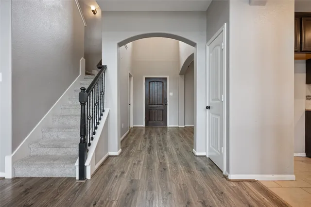 a view of a hallway view with wooden floor and staircase