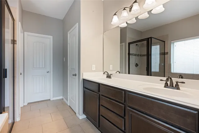 a bathroom with a double vanity sink and a mirror