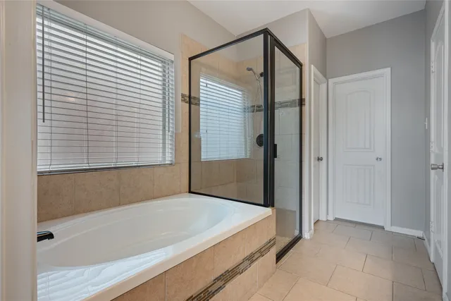 a bathroom with a bathtub and a shower