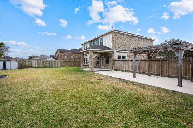a view of a house with a yard and a basket ball court