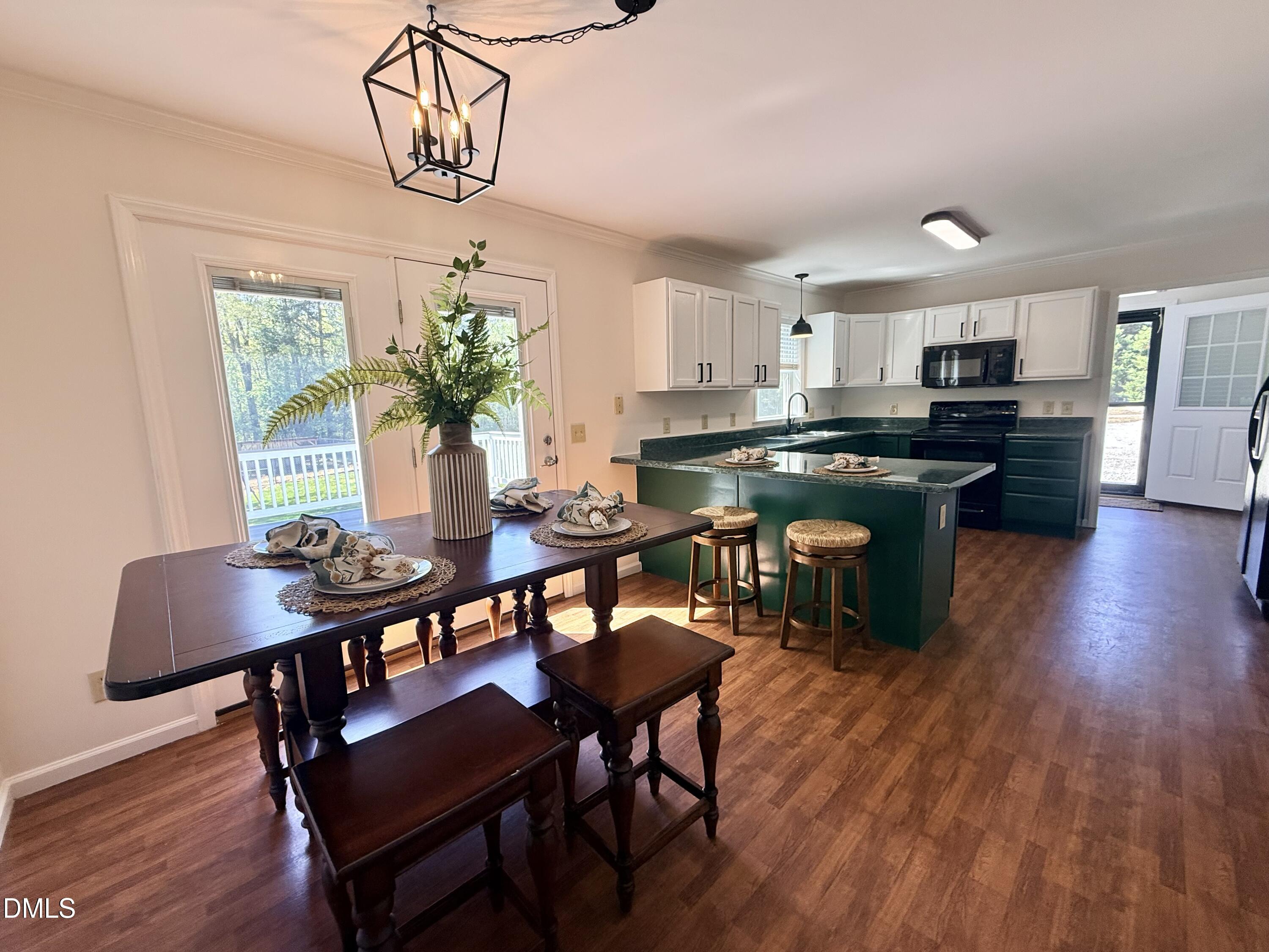 2429 Halifax Road Roxboro, NC 27573 - Photo 13 of 54 a kitchen with a dining table chairs stove and kitchen view