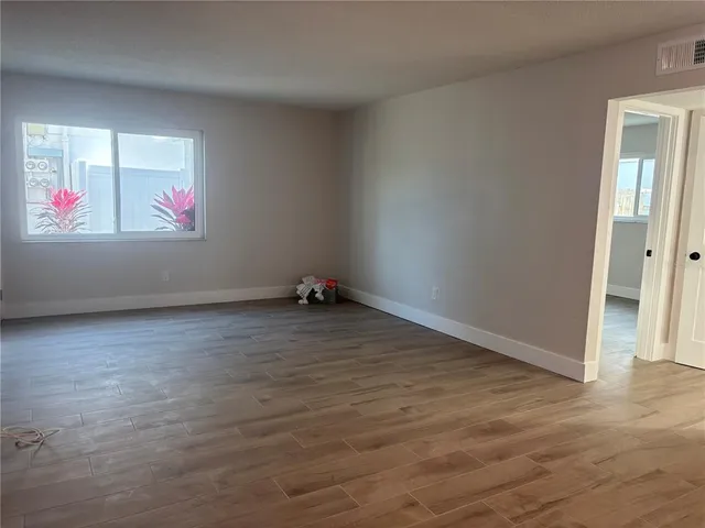 a kitchen with a sink cabinets stainless steel appliances and a window
