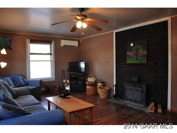 357 Martin Kings Road Charlottesville, VA 22902 - Photo 8 of 18 a living room with furniture a flat screen tv and a fireplace