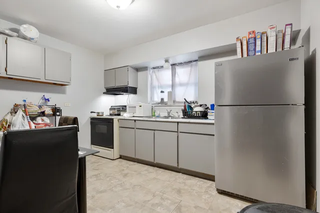 a kitchen with stainless steel appliances granite countertop a refrigerator sink and cabinets