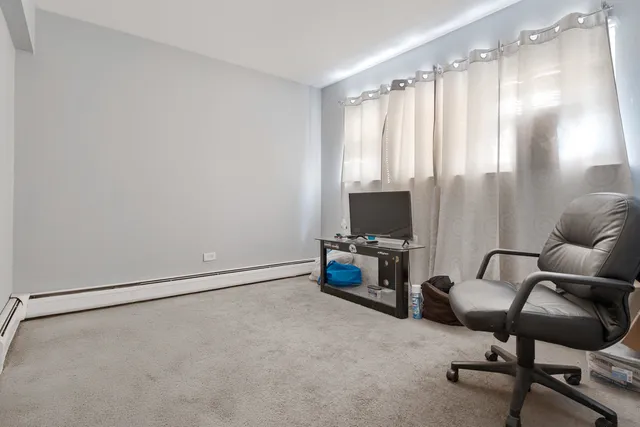 a view of a livingroom with workspace and a window