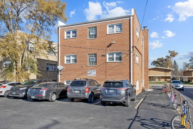 a view of a cars park in front of a building