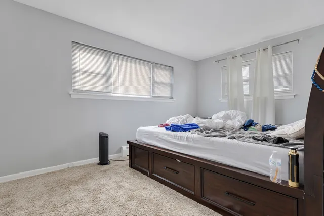 a room with kitchen island stainless steel appliances a sink window and cabinets