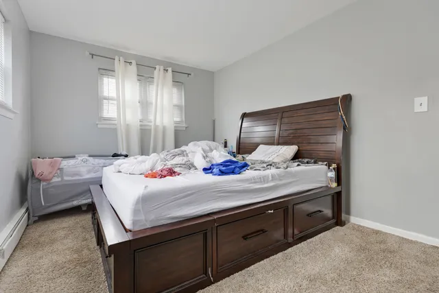 a bedroom with a bed and a dresser