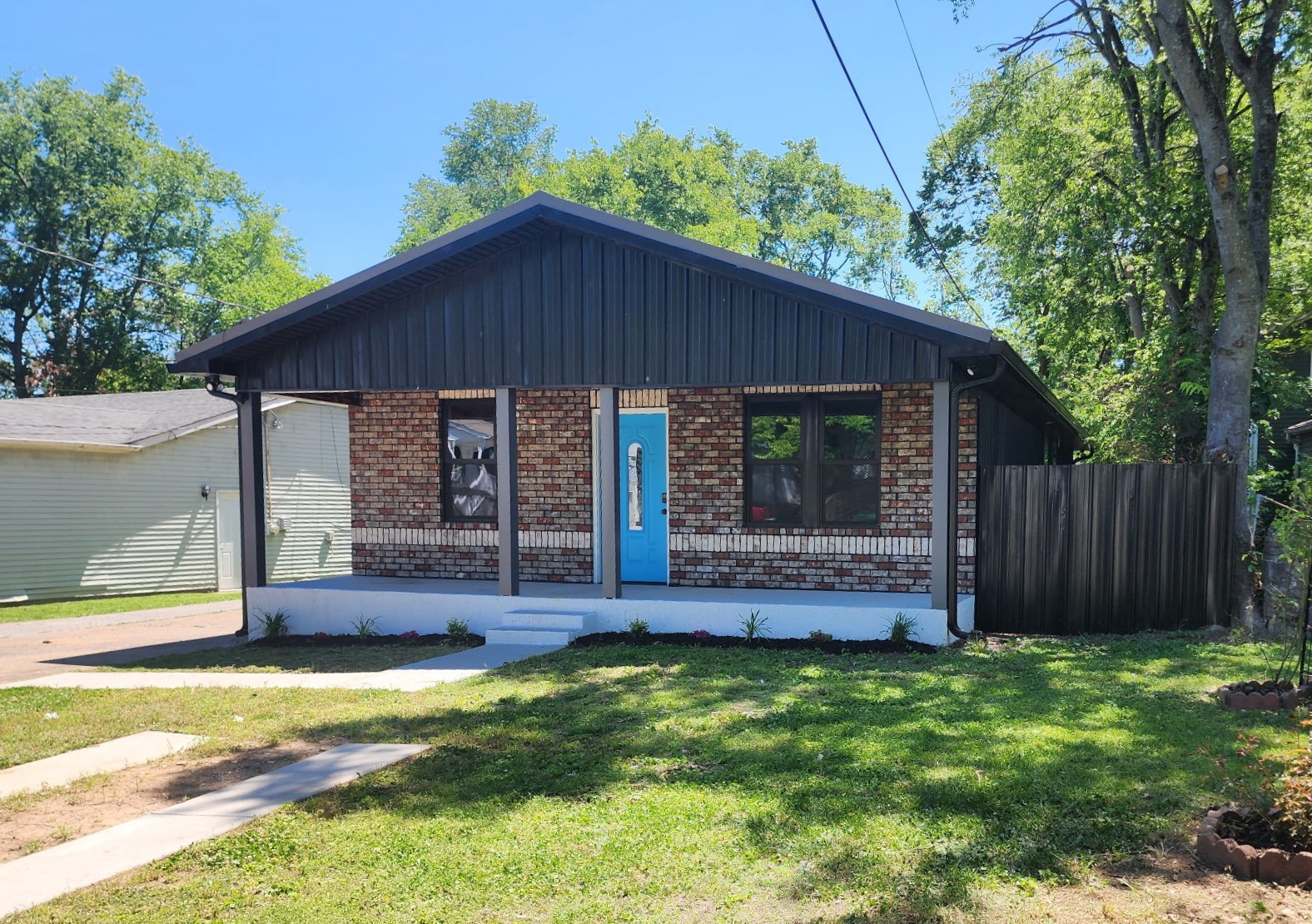 244 Warrior Road Madison, TN 37115 - Photo 22 of 24 a view of a house with a yard potted plants and large tree