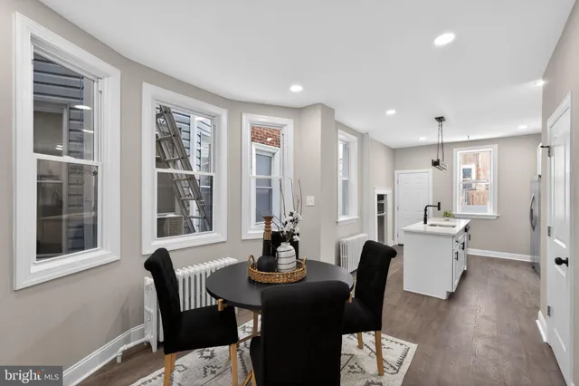 a view of a dining room with furniture window and wooden floor