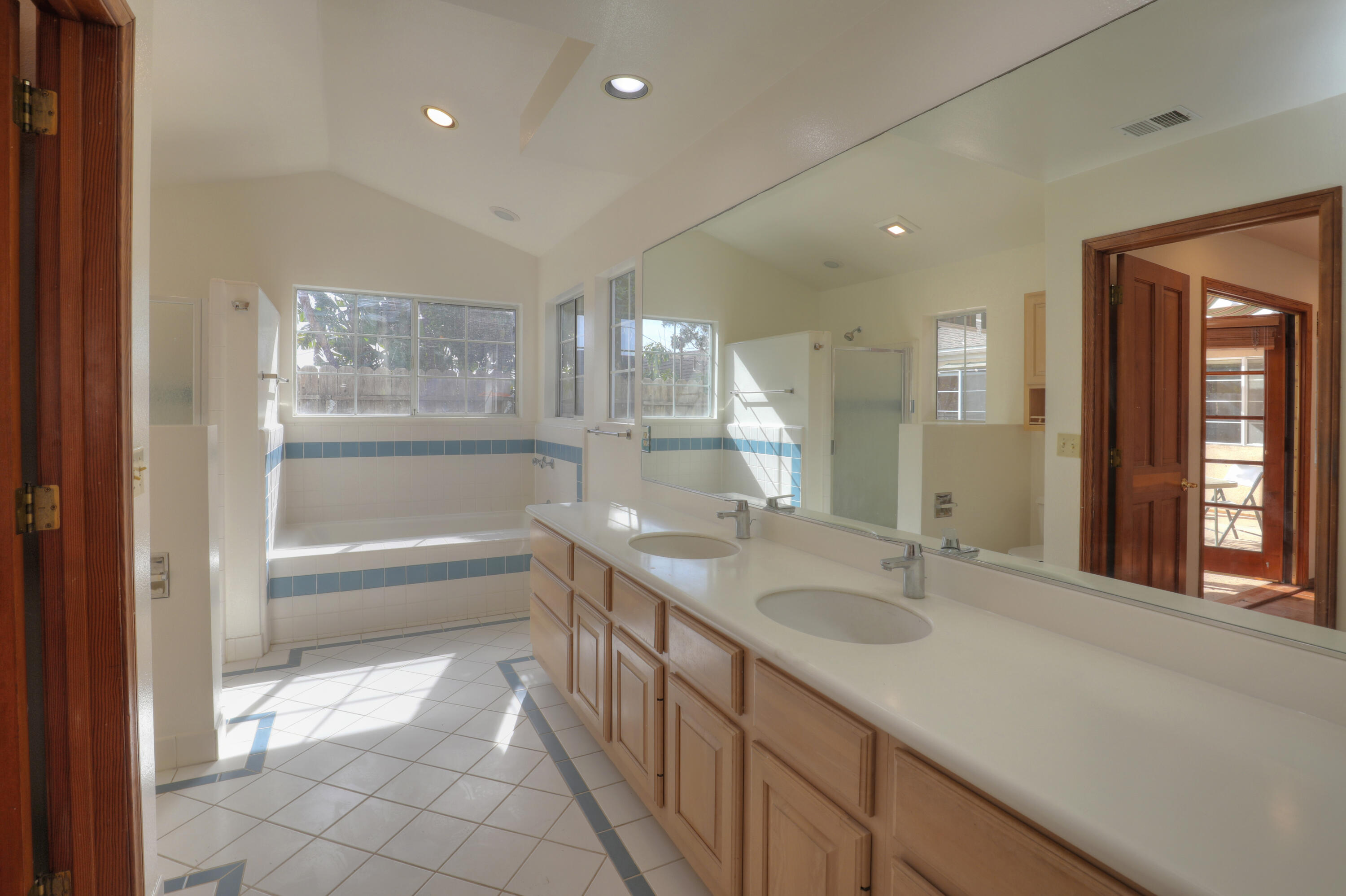 129 San Clemente Santa Barbara, CA 93109 - Photo 15 of 23 a bathroom with a sink a large mirror and a bathtub