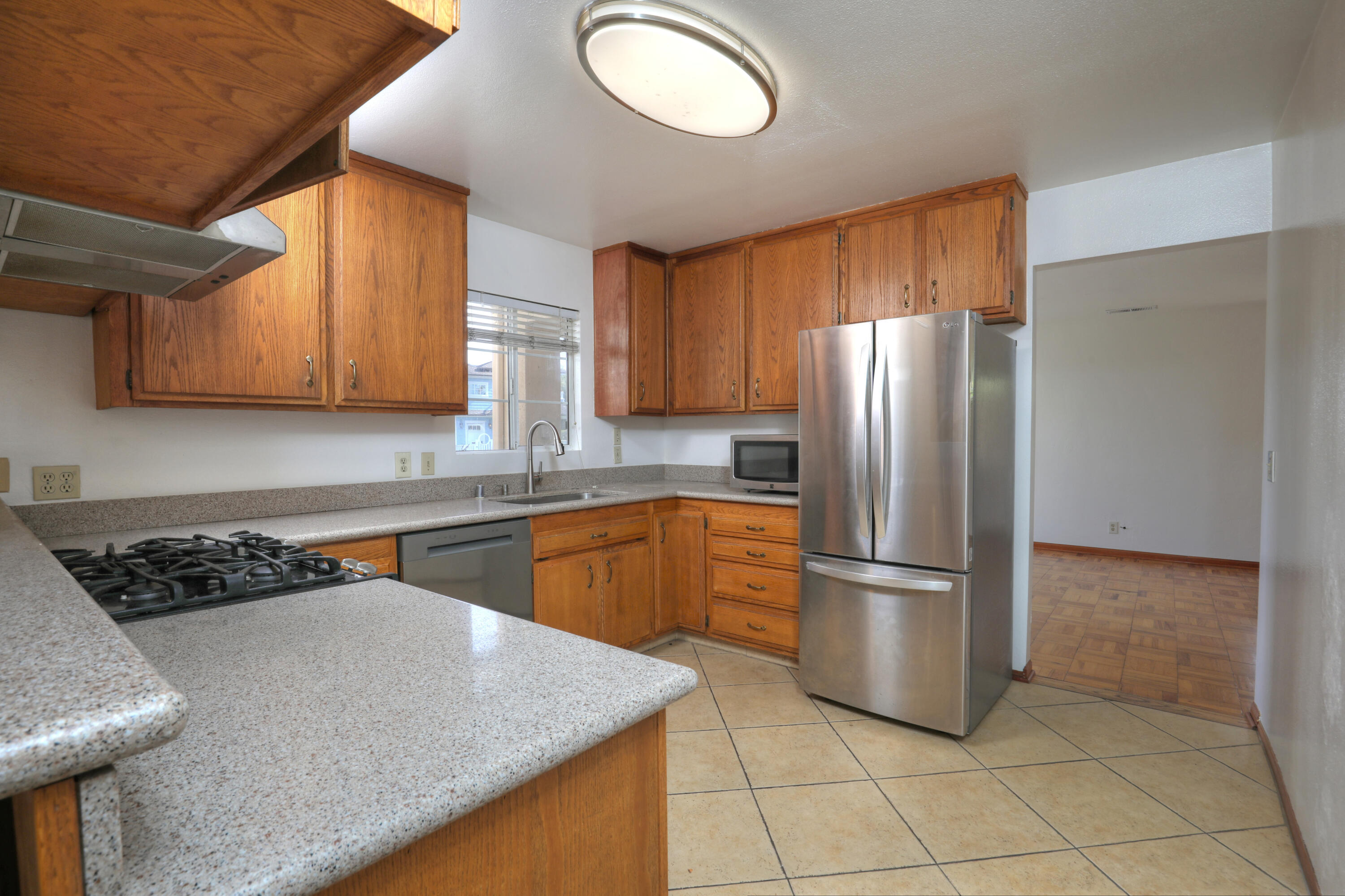 129 San Clemente Santa Barbara, CA 93109 - Photo 6 of 23 a kitchen with stainless steel appliances granite countertop a refrigerator sink and cabinets