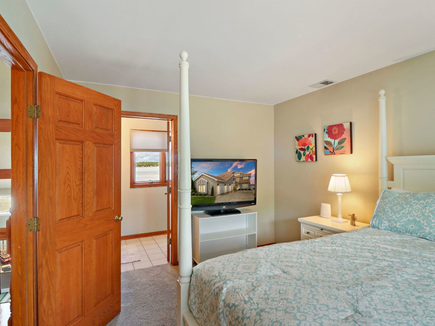 132 Eagle Point Road Fox Lake, IL 60020 - Photo 29 of 63 a bedroom with a bed and a view of en suite bathroom