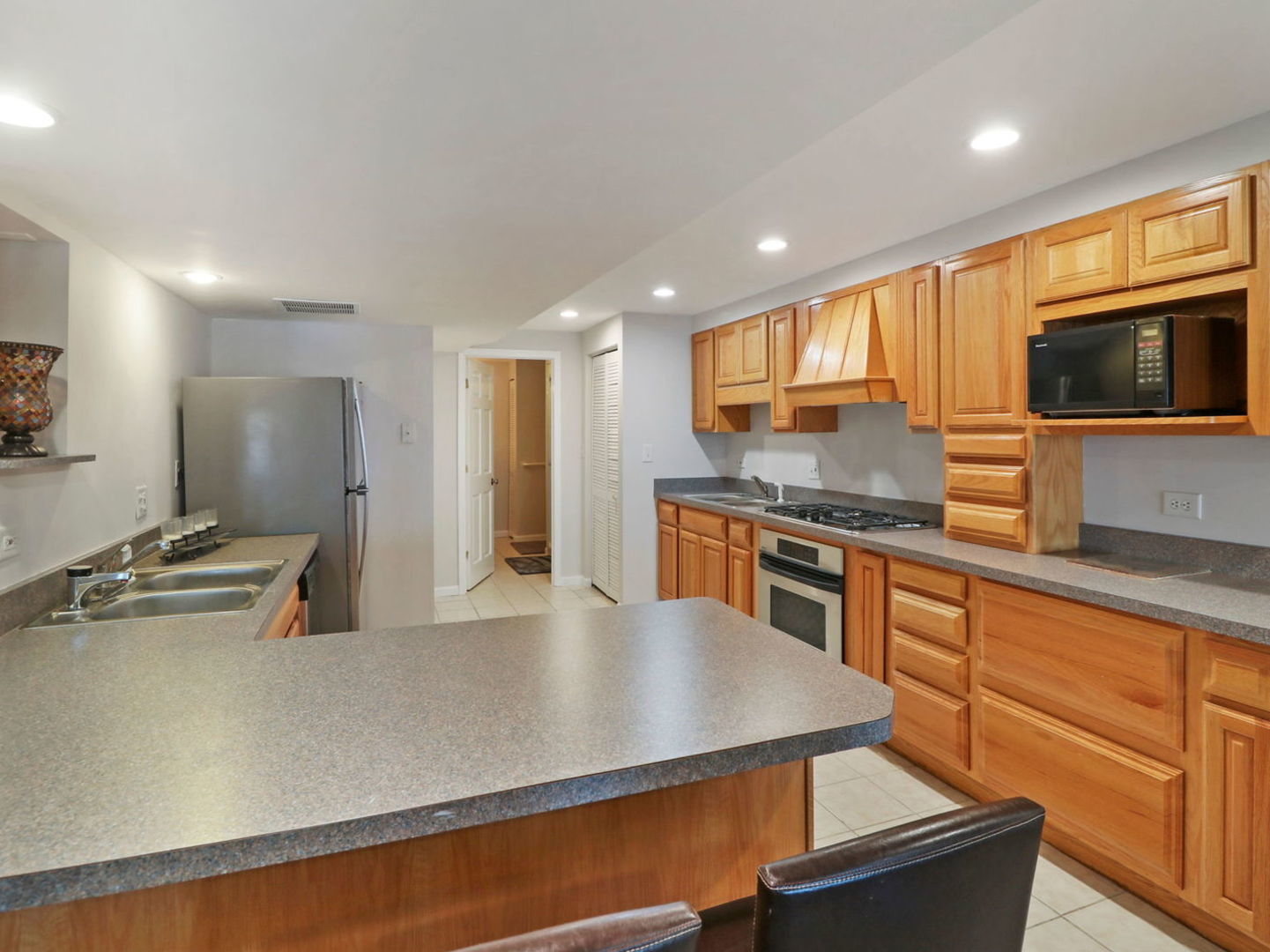 132 Eagle Point Road Fox Lake, IL 60020 - Photo 38 of 63 a kitchen with stainless steel appliances granite countertop a sink a stove top oven a counter space and cabinets