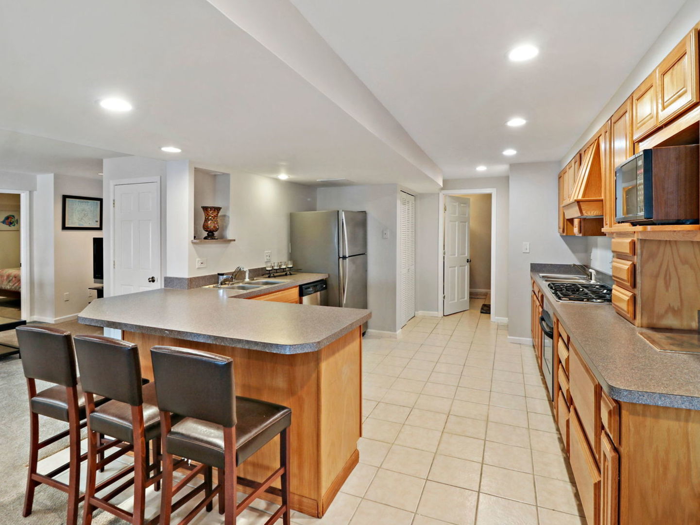 132 Eagle Point Road Fox Lake, IL 60020 - Photo 39 of 63 a kitchen with stainless steel appliances granite countertop a sink and a refrigerator
