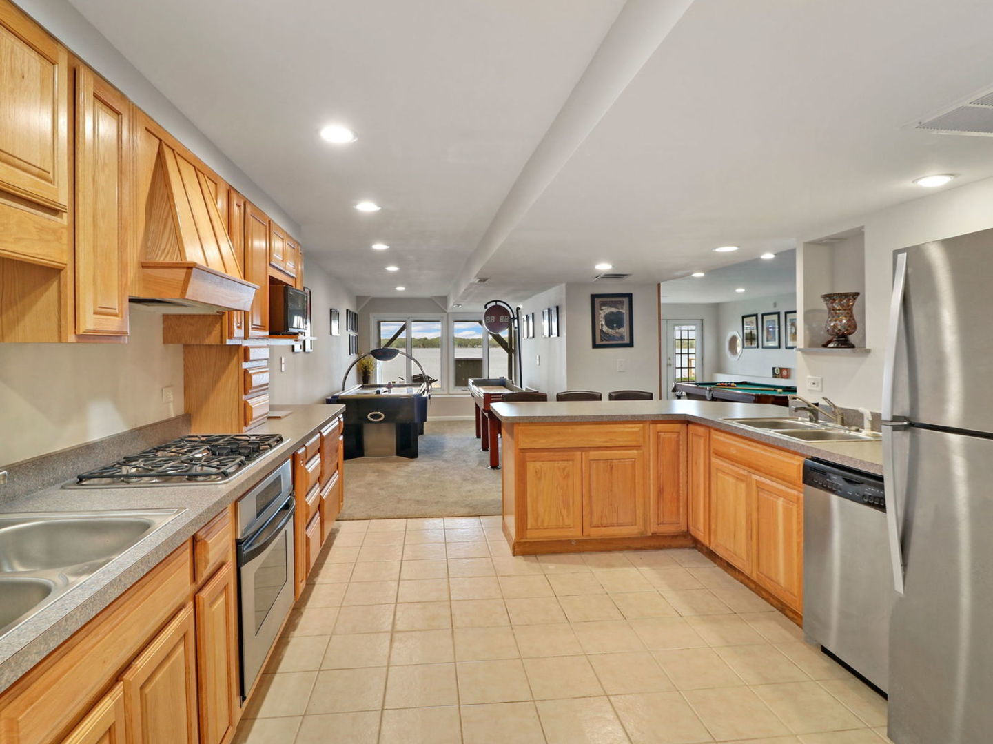 132 Eagle Point Road Fox Lake, IL 60020 - Photo 40 of 63 a kitchen with stainless steel appliances granite countertop a stove a sink dishwasher and a refrigerator with wooden floor