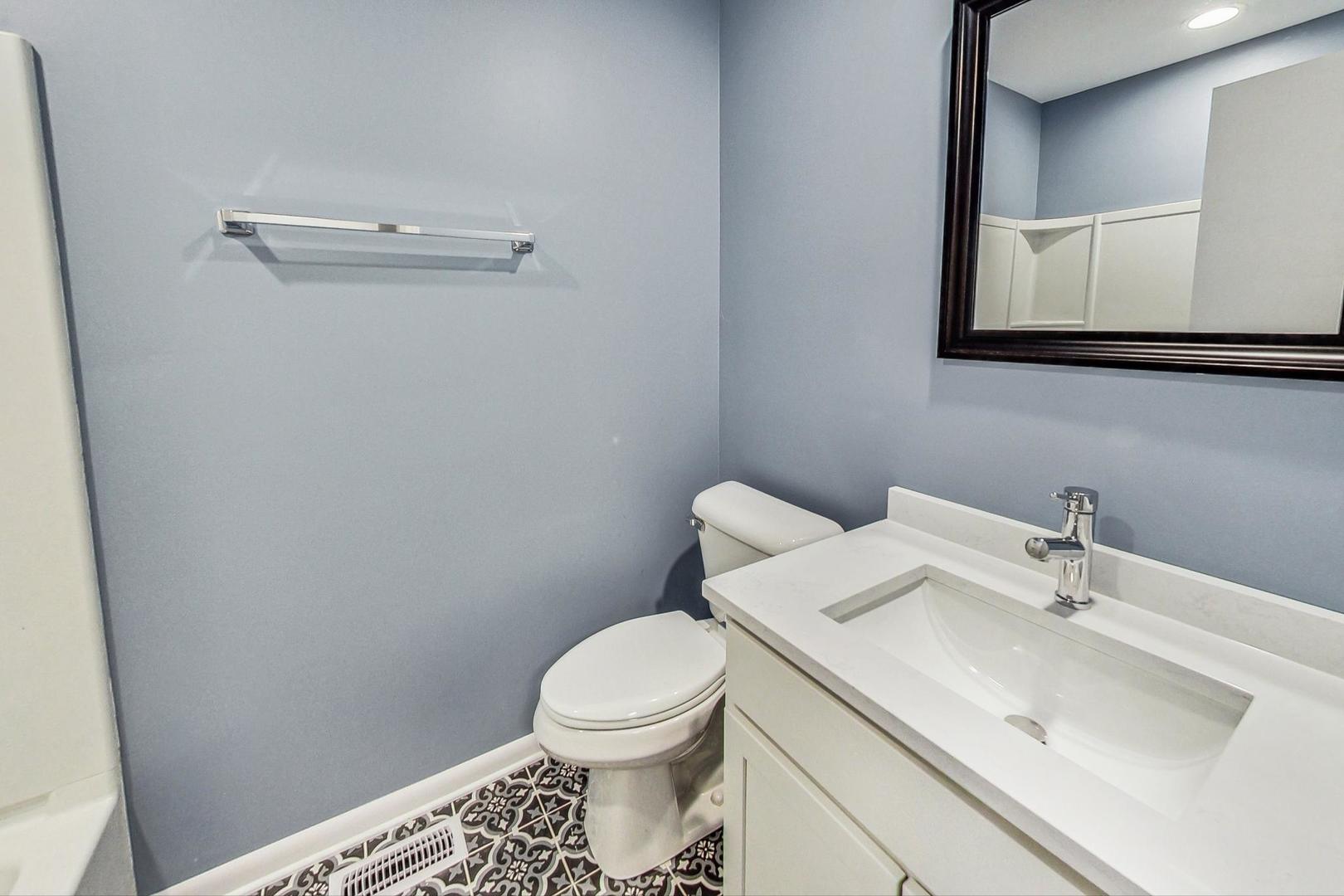 830 Russell Avenue Winthrop Harbor, IL 60096 - Photo 17 of 33 a bathroom with a sink a toilet and mirror