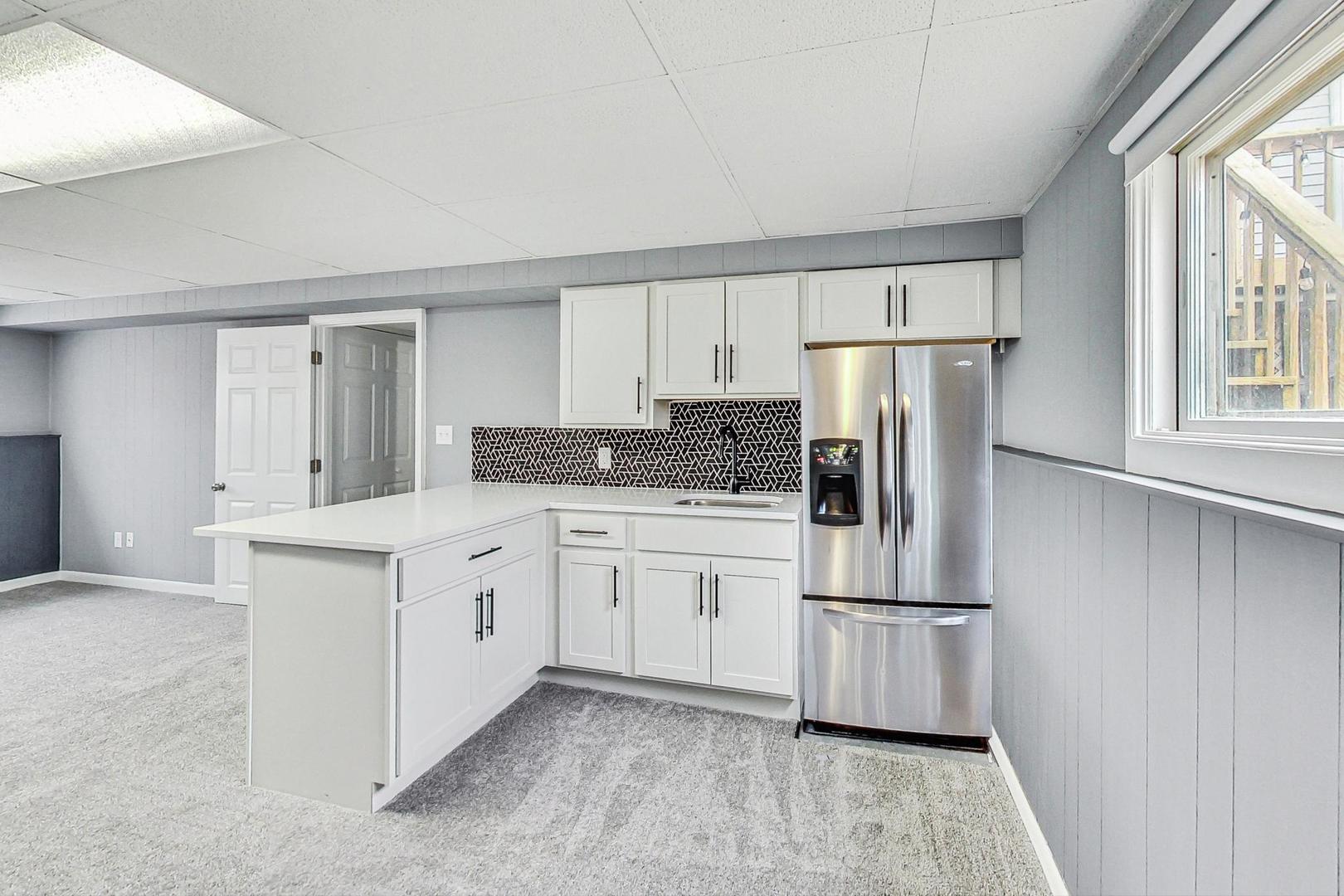 830 Russell Avenue Winthrop Harbor, IL 60096 - Photo 20 of 33 a kitchen with white cabinets and stainless steel appliances