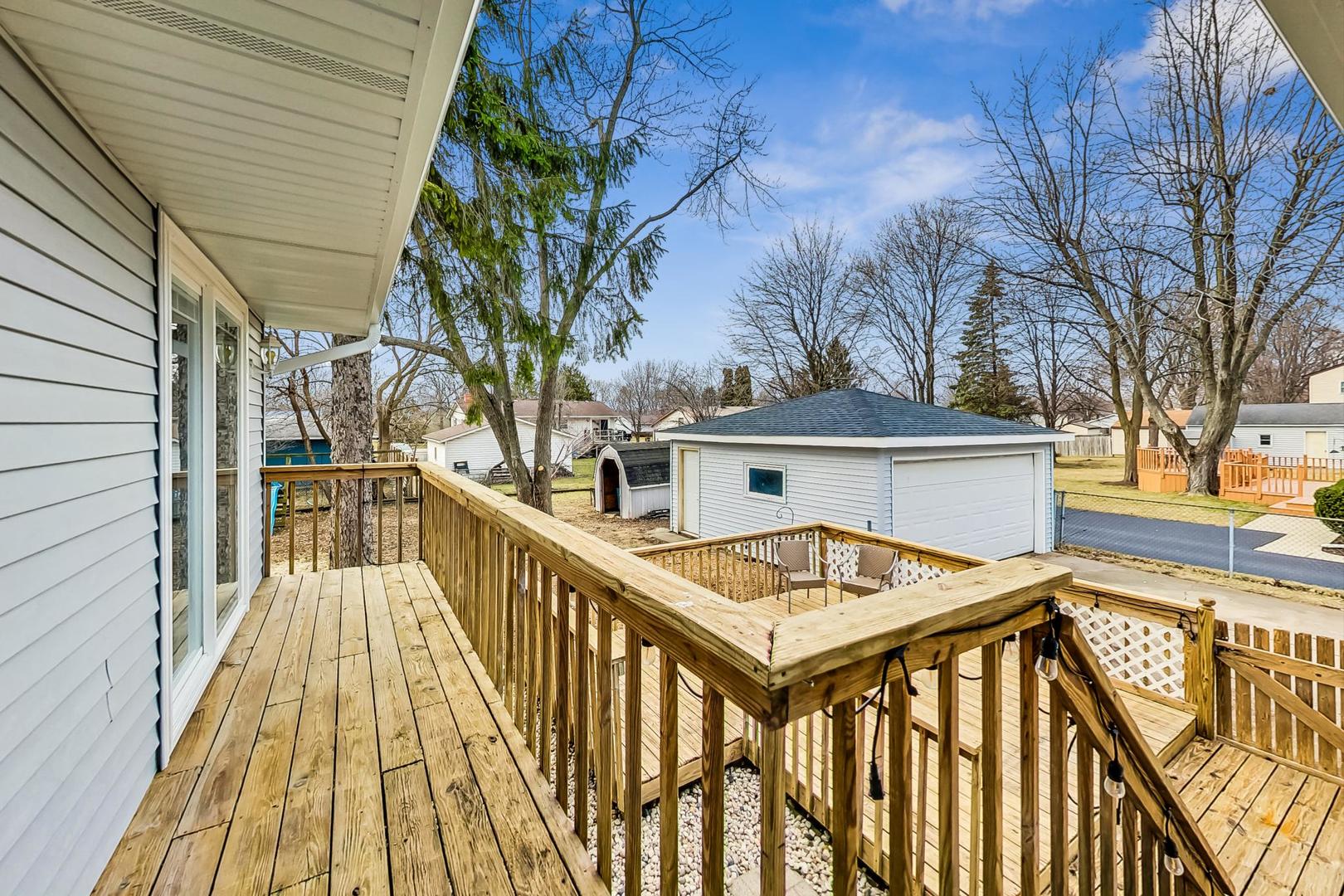 830 Russell Avenue Winthrop Harbor, IL 60096 - Photo 32 of 33 a view of a house with wooden deck and trees