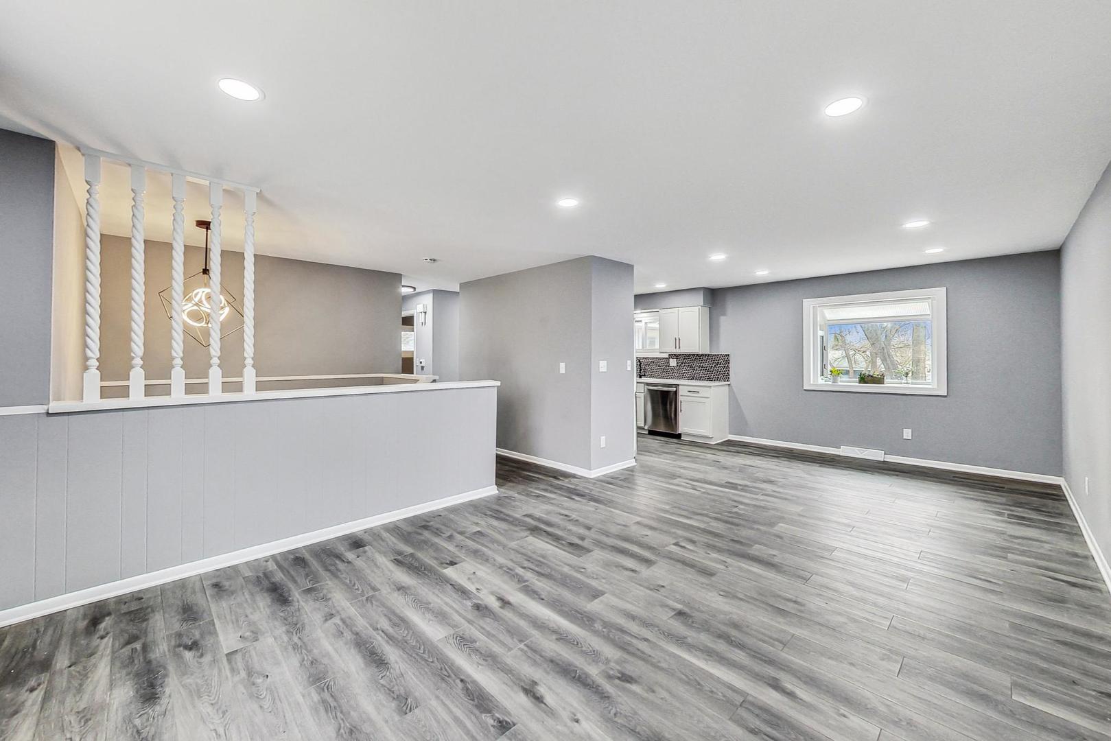 830 Russell Avenue Winthrop Harbor, IL 60096 - Photo 5 of 33 a view of an empty room with a window and wooden floor