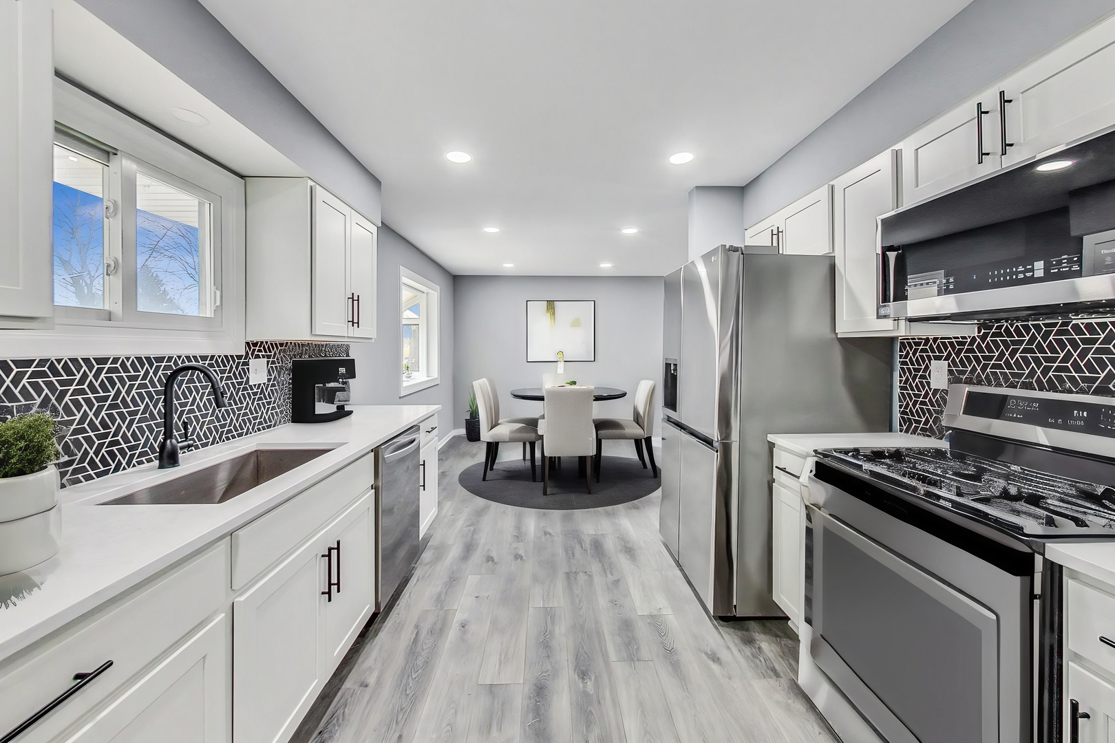 830 Russell Avenue Winthrop Harbor, IL 60096 - Photo 8 of 33 a kitchen with white cabinets and appliances