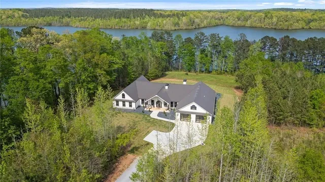 a view of swimming pool with outdoor seating and a potted plant