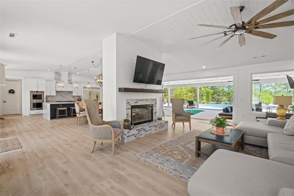 840 Old Driver Road Whitesburg, GA 30185 - Photo 14 of 88 a living room with furniture a fireplace and a flat screen tv