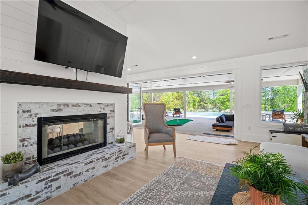 840 Old Driver Road Whitesburg, GA 30185 - Photo 18 of 88 a living room with furniture a large window and a fireplace