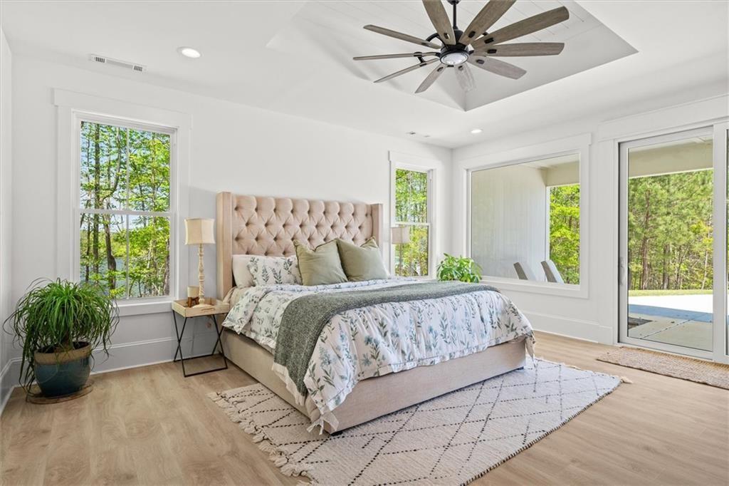 840 Old Driver Road Whitesburg, GA 30185 - Photo 27 of 88 a bedroom with a large bed and a potted plant