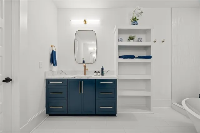 a bathroom with a sink a toilet and mirror