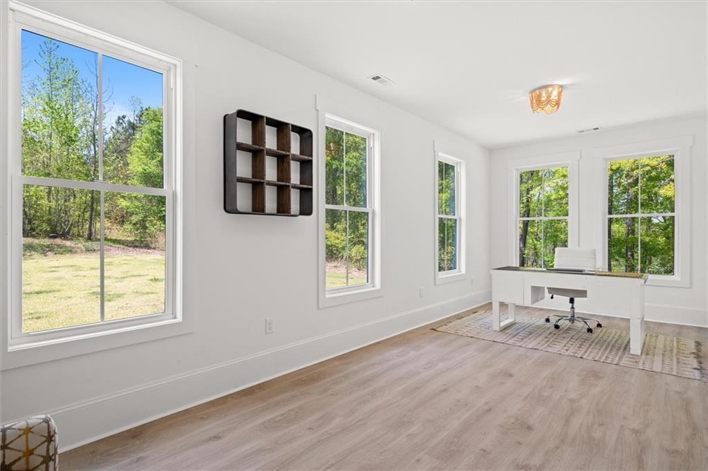 840 Old Driver Road Whitesburg, GA 30185 - Photo 37 of 88 a view of an empty room with a window and wooden floor