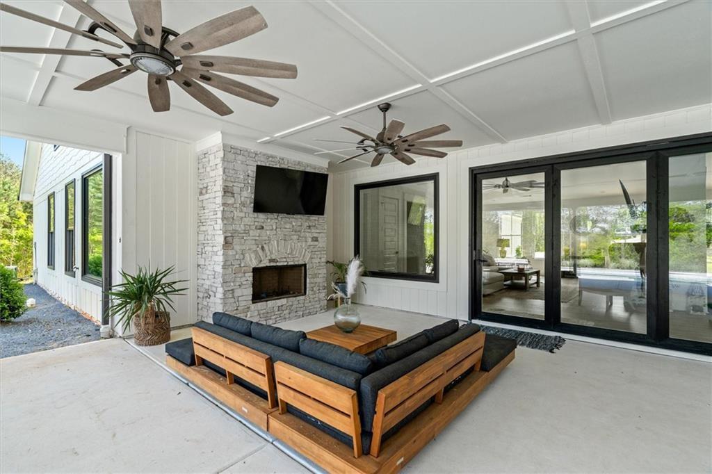 840 Old Driver Road Whitesburg, GA 30185 - Photo 64 of 88 a living room with furniture a flat screen tv and a fireplace