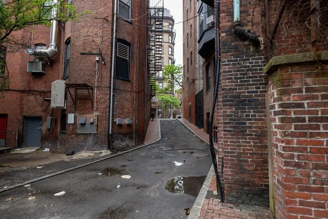 a view of a brick house with a street
