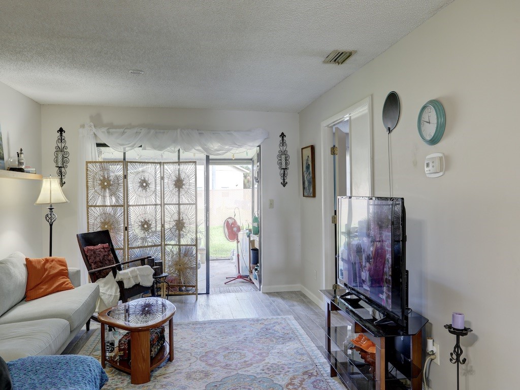 6022 Indrio Road, Unit G3 Fort Pierce, FL 34951 - Photo 11 of 36 a living room with furniture and a window