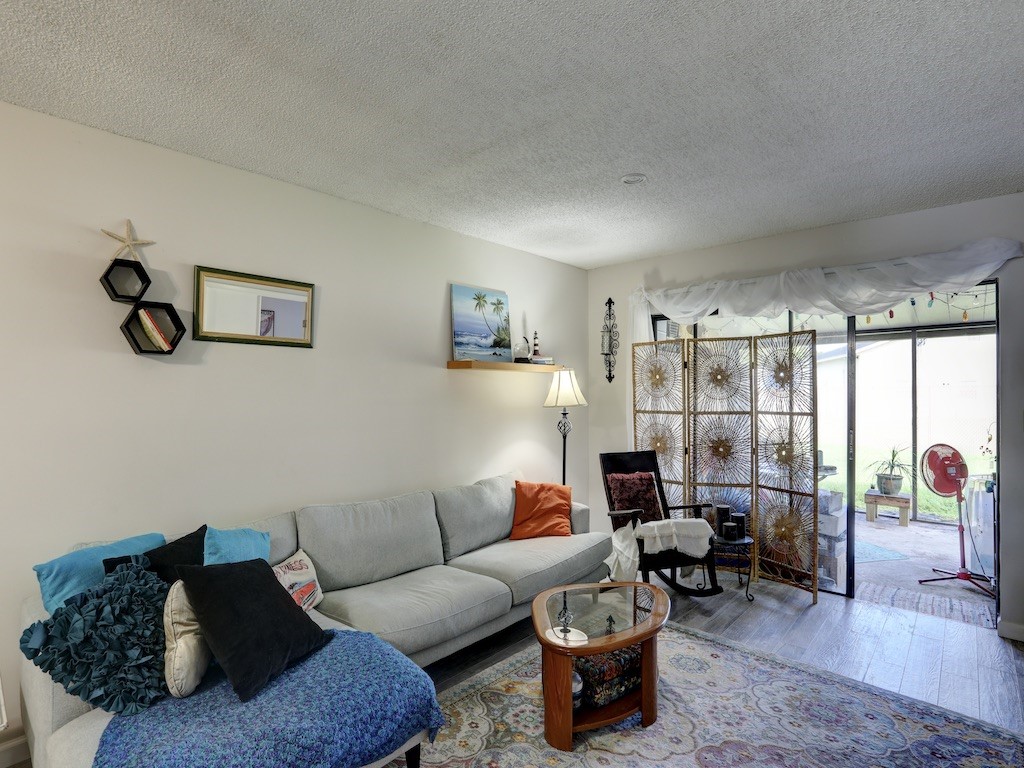 6022 Indrio Road, Unit G3 Fort Pierce, FL 34951 - Photo 12 of 36 a living room with furniture and a large window