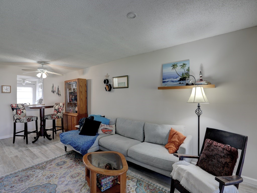 6022 Indrio Road, Unit G3 Fort Pierce, FL 34951 - Photo 13 of 36 a living room with furniture a lamp and a window