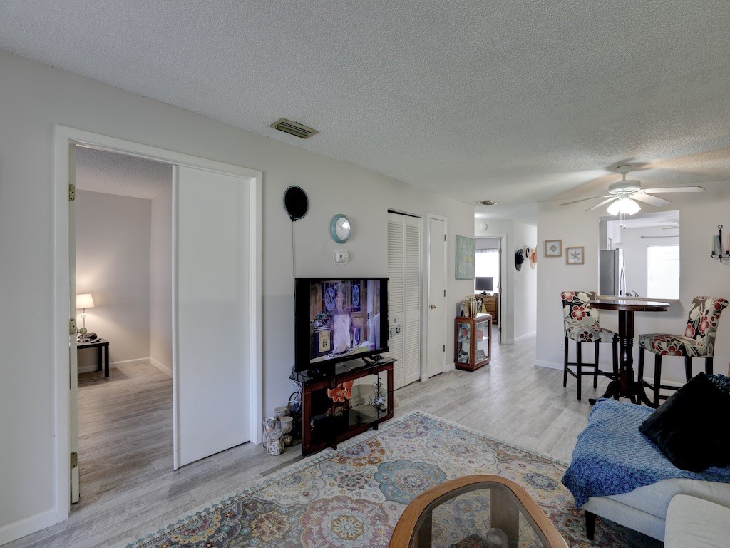 6022 Indrio Road, Unit G3 Fort Pierce, FL 34951 - Photo 14 of 36 a living room with furniture and a flat screen tv