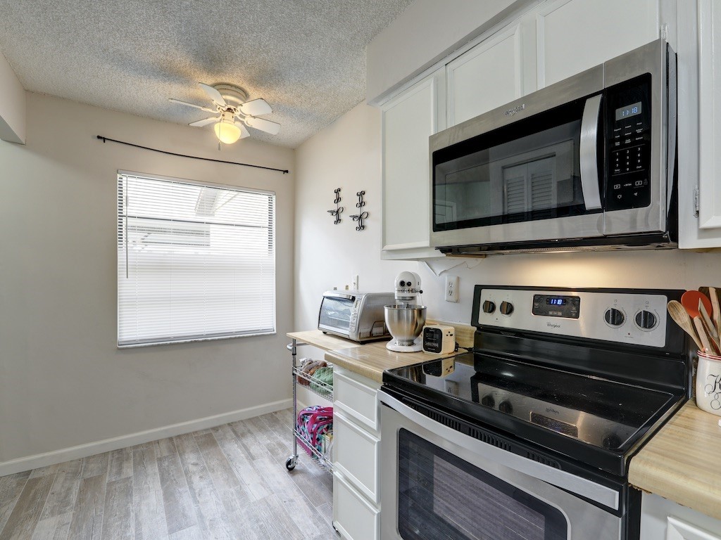 6022 Indrio Road, Unit G3 Fort Pierce, FL 34951 - Photo 19 of 36 a kitchen with a stove and a microwave