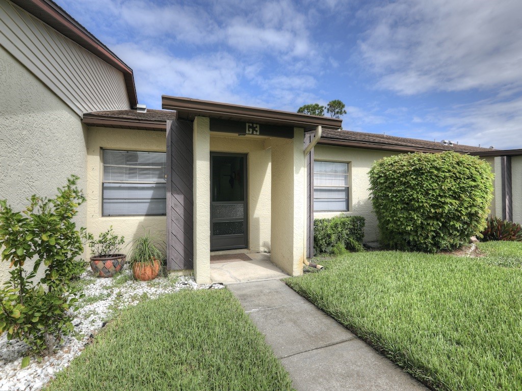 6022 Indrio Road, Unit G3 Fort Pierce, FL 34951 - Photo 2 of 36 a view of a house with a yard