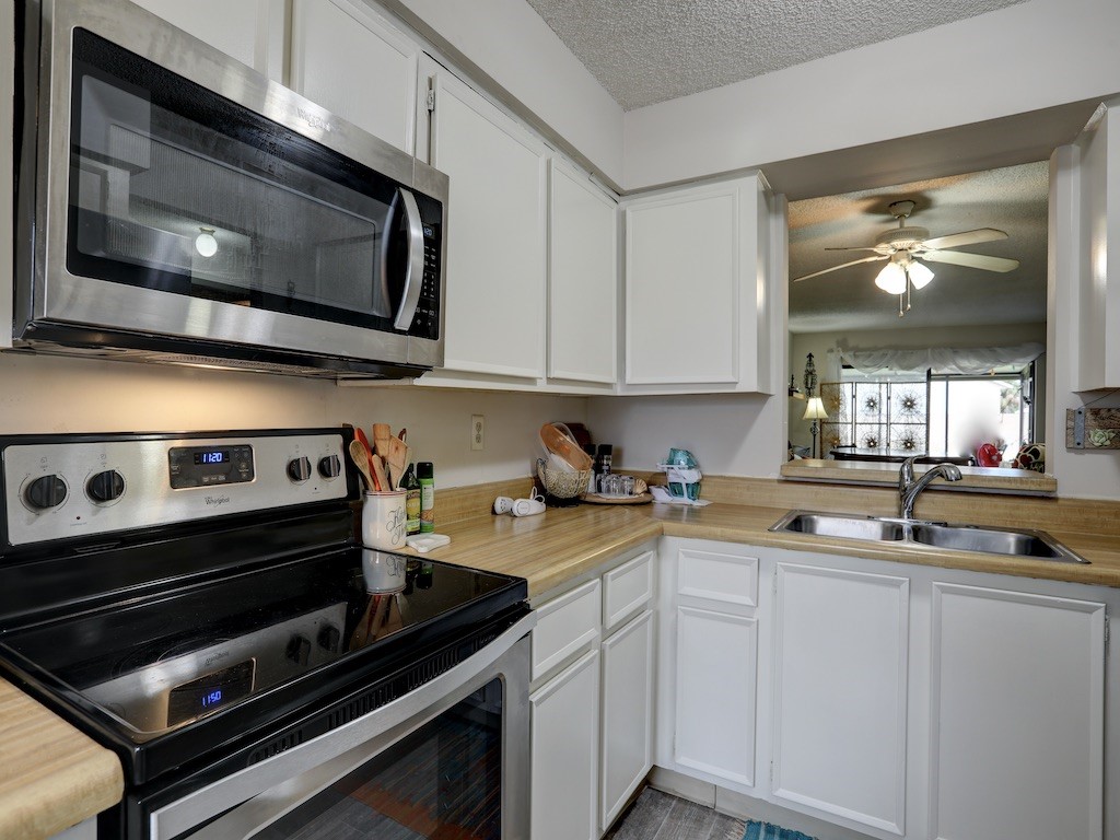 6022 Indrio Road, Unit G3 Fort Pierce, FL 34951 - Photo 21 of 36 a kitchen with a stove microwave and sink