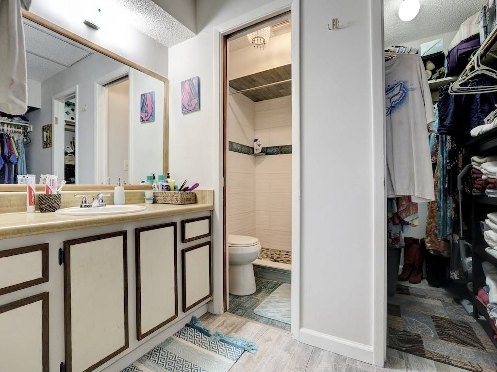 6022 Indrio Road, Unit G3 Fort Pierce, FL 34951 - Photo 27 of 36 a bathroom with a double vanity sink toilet and shower
