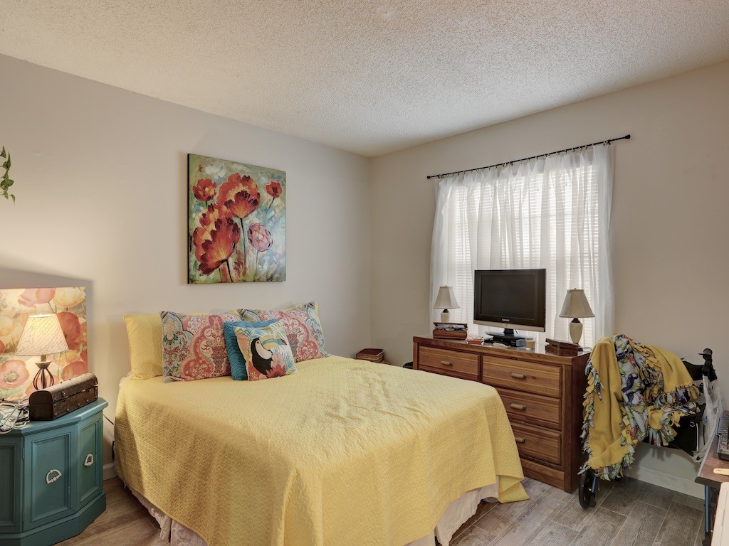 6022 Indrio Road, Unit G3 Fort Pierce, FL 34951 - Photo 30 of 36 a bedroom with a bed and flat screen tv