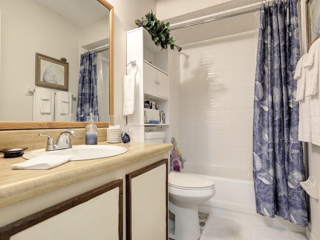 6022 Indrio Road, Unit G3 Fort Pierce, FL 34951 - Photo 32 of 36 a bathroom with a granite countertop sink toilet a mirror and shower