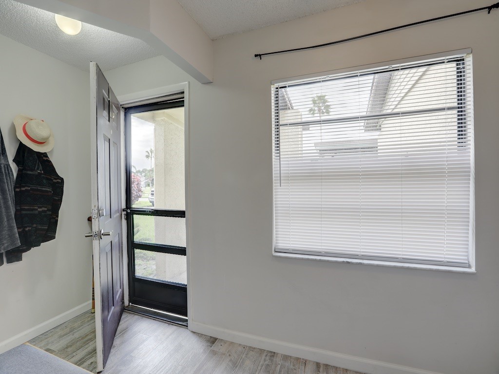 6022 Indrio Road, Unit G3 Fort Pierce, FL 34951 - Photo 6 of 36 a room with a wooden floor and a window