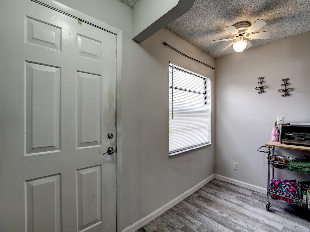 6022 Indrio Road, Unit G3 Fort Pierce, FL 34951 - Photo 8 of 36 wooden floor in an empty room with a window